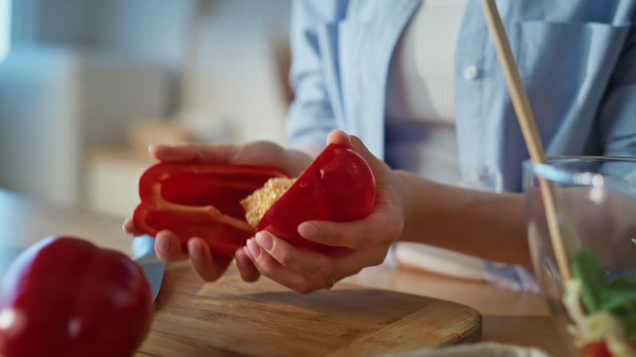 Lady hands slicing pepper on chopping board home kitchen closeup. Cook cutting