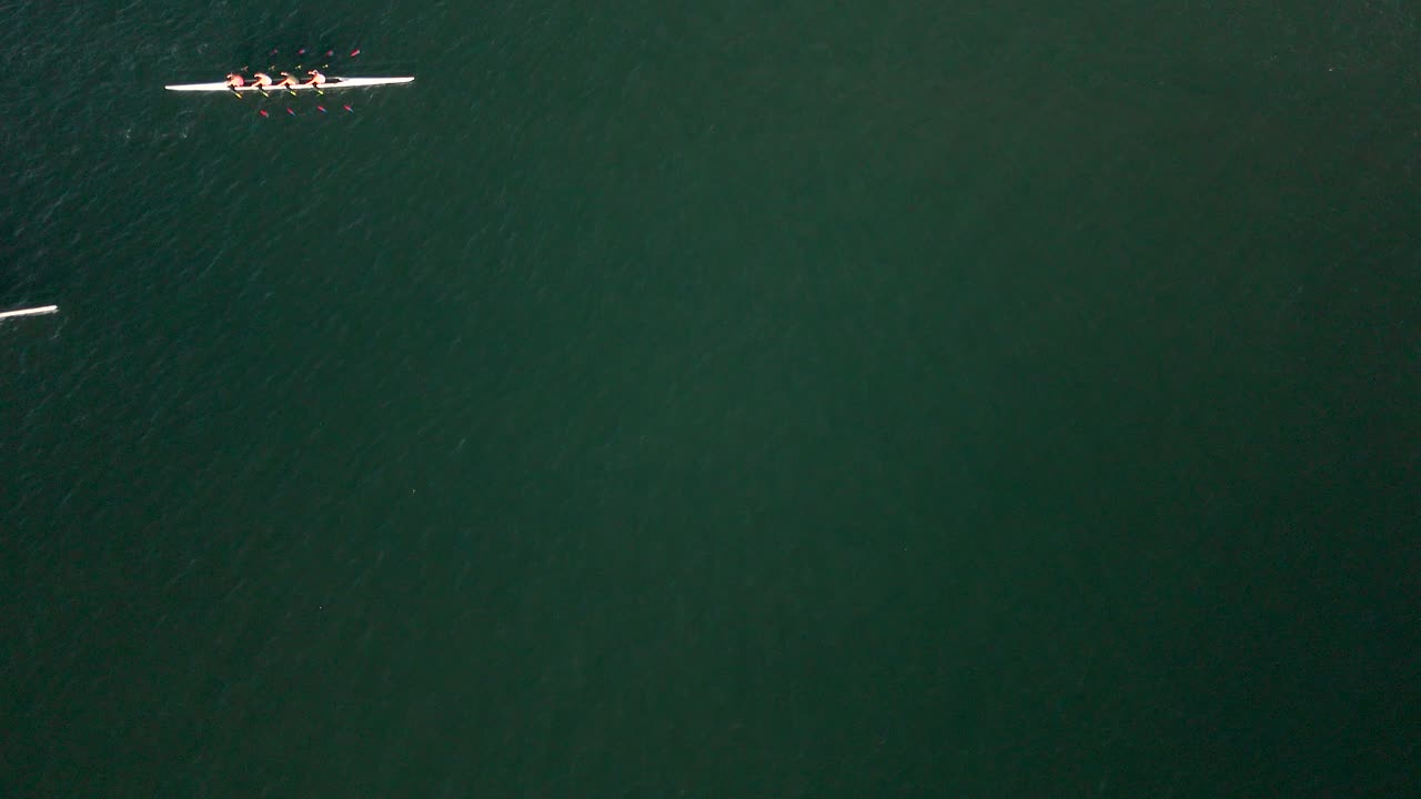 Top Down View Of Boat Teams Rowing In The Ocean In Marina Del Rey, Los Angeles, California - Drone Shot