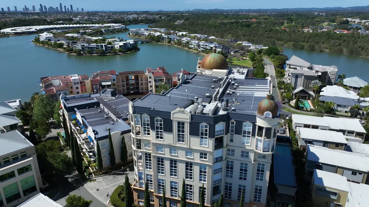 Stunning aerial view of Surfers Paradise skyline, captured from the serene Emerald Lakes Village, showcasing the vibrant cityscape against a picturesque backdrop.