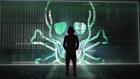 Silhouette of hooded hacker standing in front of a digital screen wall with various code, words and virus symbols