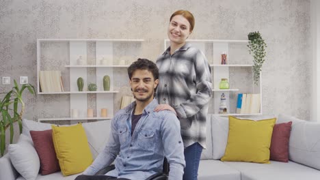 happy disabled man and his girlfriend look at camera and smile.