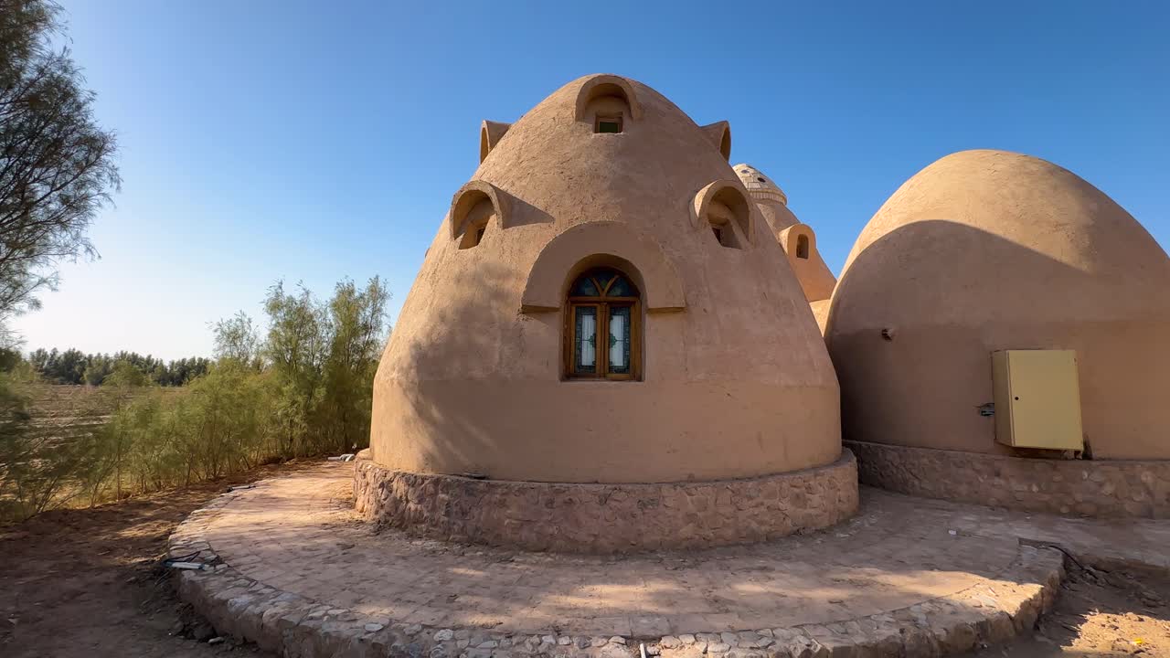 Old traditional arch dome house caravansary in Iran desert architecture mudbrick structure mountain landscape of summer scenic sand dune horizon destination sunlight outdoor wanderlust holiday travel