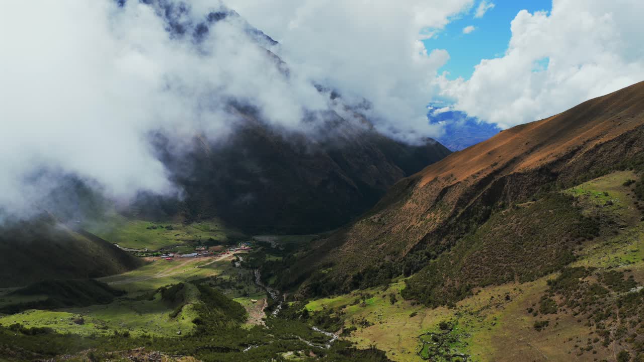 Peruvian Andes range Soray town Laguna Lake Humantay hiking Machu Pichhu Inca snow capped high altitude Salkantay trek Peru aerial drone rainy season sunny morning clouds Cusco forwards motion