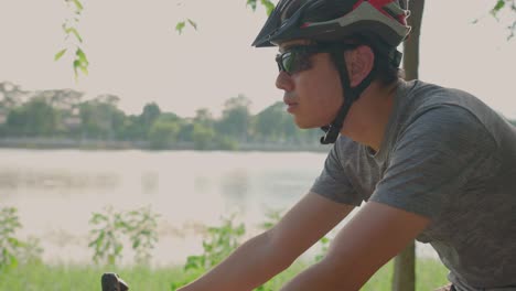 man cycling by the lake