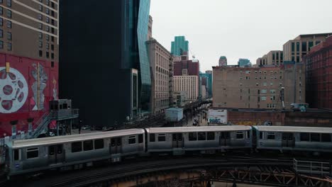 cityscape of long chicago commuter subway sparking as it passes through downtown center