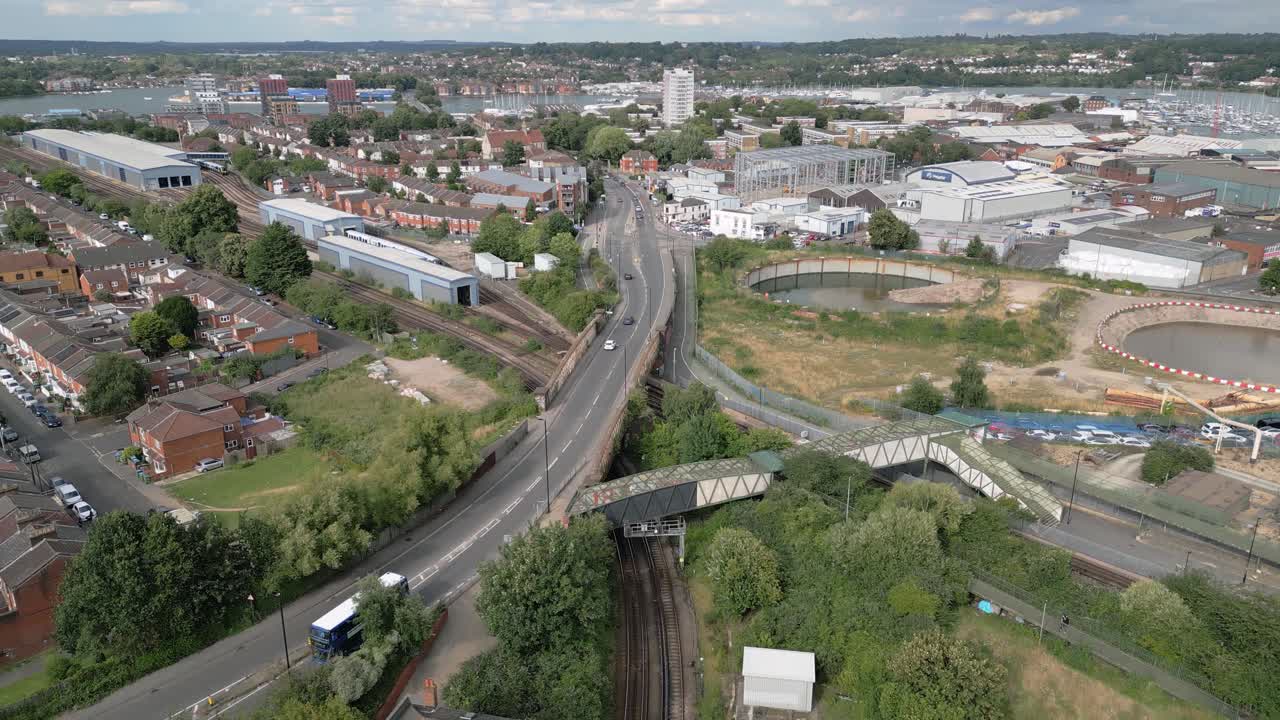 Cars And Bus Driving Along The Northam Traincare Facility Near St Mary's Stadium In Southampton, England, UK. - aerial shot