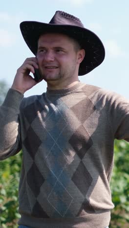 farmer talking on phone in field