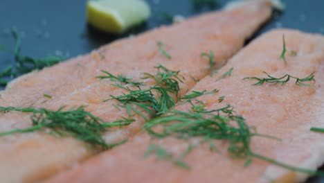 close up of mountain char filet with dill in frying pan
