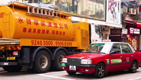 taxi and truck on busy hong kong street