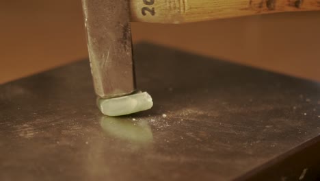 smashing greenstone from new zealand with a hammer in slow motion - close up shot