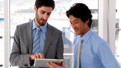 Businessman-using-tablet-pc-with-his-colleague