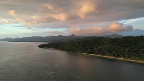 Aerial-shot-of-Mamangal-Beach-with-lush-greenery-and-sunset-hues,-Catanduanes,-Philippines,-tranquil