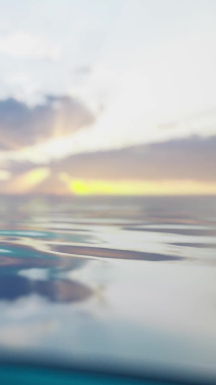 Sunset view over water with clouds and reflections