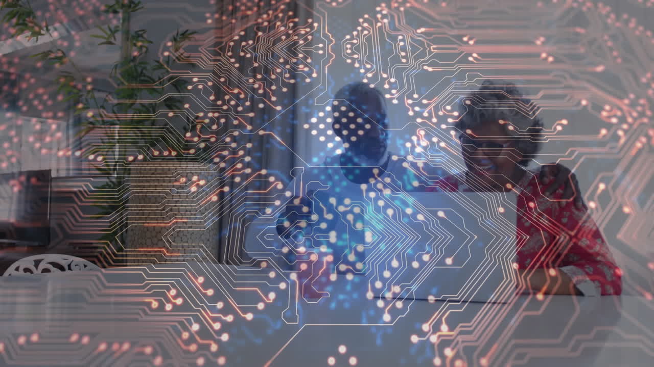 Man gesturing toward silver laptop and woman watching in office, showing technology circuit pattern