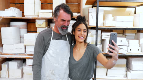 male and female potter taking selfie with mobile phone 4k