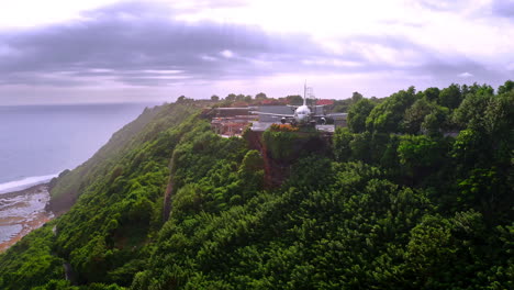 Retired-jet-plane-being-turned-into-luxurious-hotel-on-cliff-above-sea