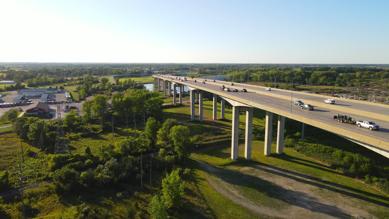Freeway road and bridge over river with traffic in USA, aerial view