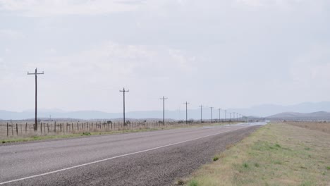 Passing-car-on-empty-highway,-West-Texas