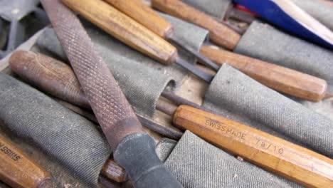 a woodcarvers woodworking toolkit full of high quality chisels, slow pan from left to right