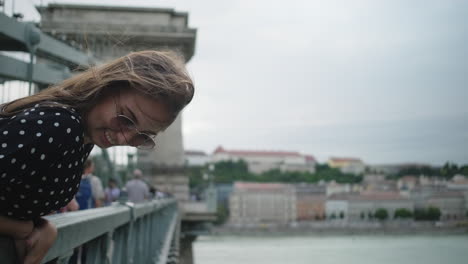 happy young woman on a bridge in budapest