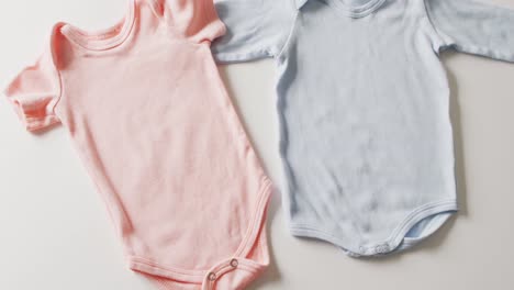 Video-of-close-up-of-blue-and-pink-baby-grows-on-white-background