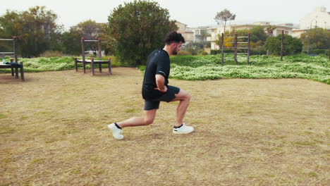 athlete warms up his legs before outdoor training