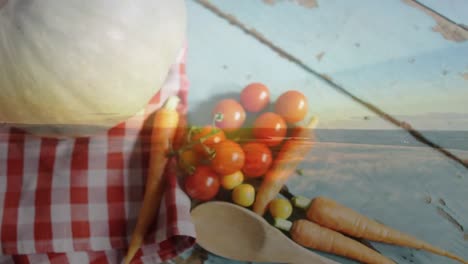 Animation-of-landscape-over-vegetables-on-wooden-background