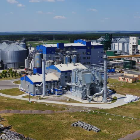 exterior of agriculture plant. grain elevator. aluminum containers for storage cereals. huge territory for agribusiness on field.