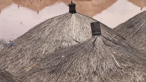 panup shot of a ugandan village in africa with thatched roofs