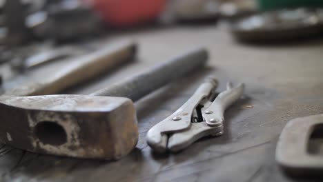 Close-up-on-tools-laying-on-table-in-workshop