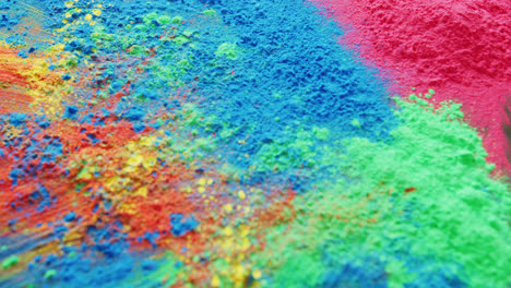 Video-of-close-up-of-multi-coloured-powders-with-copy-space-on-black-background