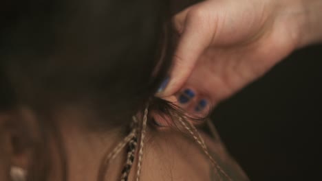 Close-Up-view-of-the-hairdresser's-hands-doing-dreads-for-a-young-woman-in-the-hair-salon.-Slow-Motion-shot