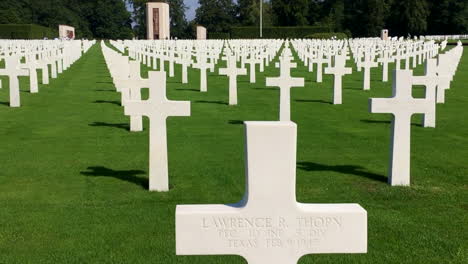 world war ii american cemetery in luxembourg, handheld walk past grave markers, general patton's grave in distance, at battle of the bulge site, hd