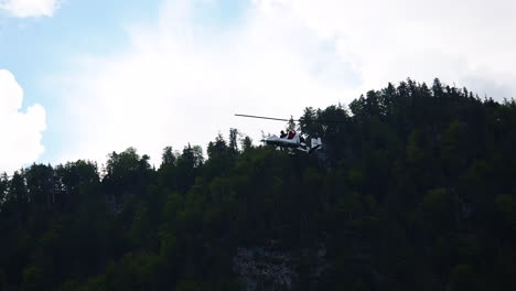 gyroplane flying in the sky over lake attersee, austria.