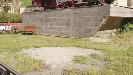 Antique-Steam-Locomotive-Display-Of-The-Narrow-gauge-Railway-Between-Borjomi-And-Bakuriani,-Georgia---tilt-up-shot