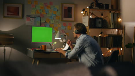 Funny-guy-listening-headphones-at-home-closeup.-Man-enjoying-favourite-music