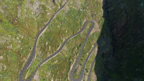 an aerial view of the narrow road snaking down the mountain