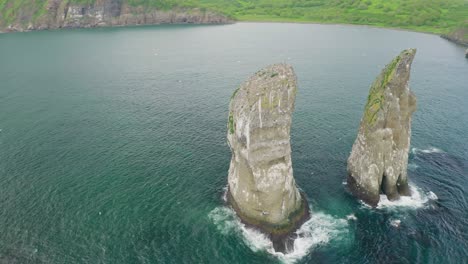 awesome circle panorama. huge rocks towers in teal bay, sea birds flying around