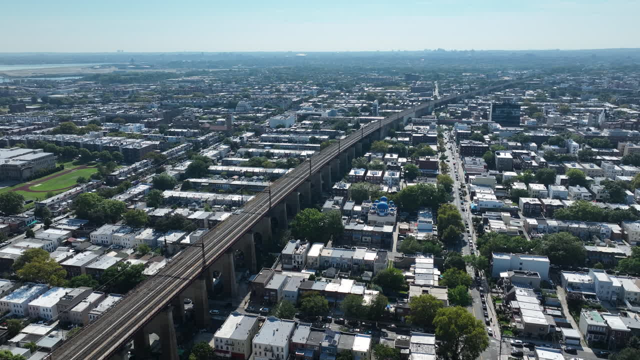Hell Gate Railroad Bridge In New York City, Across The Surrounding Neighbourhood Of Astoria, Queens. Aerial Orbiting Shot