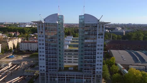 Majestic-aerial-top-view-flight-Twin-Tower-Skyscraper-at-river-Spree,-east-Berlin-Germany-evening-summer-23