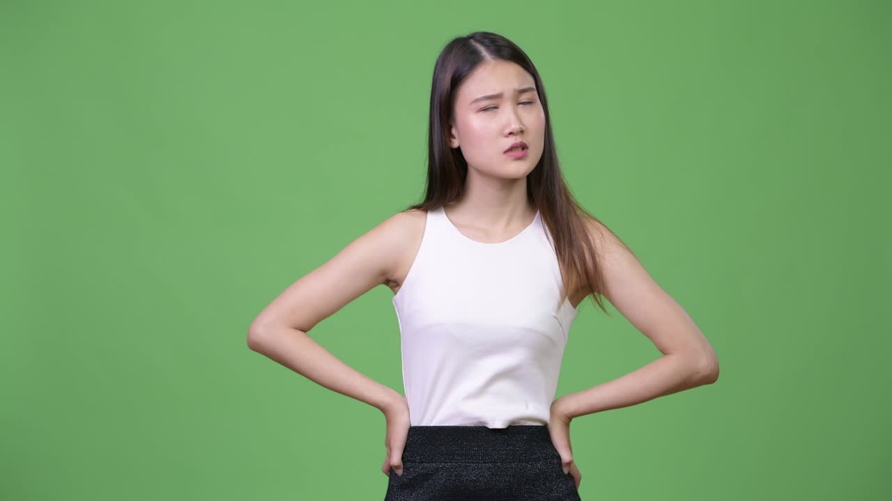 Young beautiful Asian businesswoman looking bored