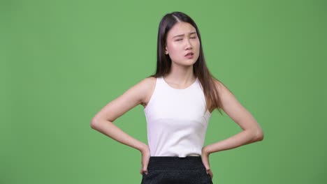 young beautiful asian businesswoman looking bored