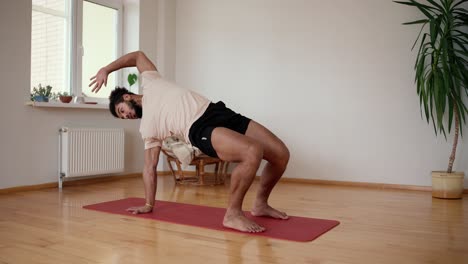 Young-man-stretching-spine,-bending-imitating-bridge-exercise