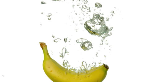 Banana-plunging-into-water-on-white-background