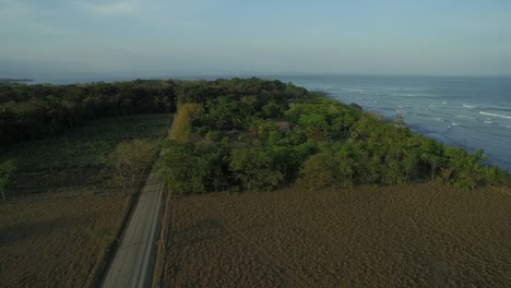 aerial view of long road with ocean on right - puerto jiménez, costa rica