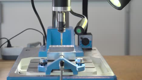 operator working on a drill press