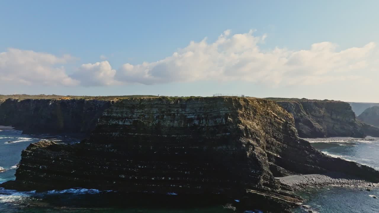 The rugged cliffs of Portugal rise majestically from the azure waters of the Atlantic Ocean