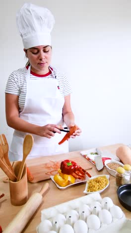 Young woman peeling vegetables using a food peeler. Cleans the peel from carrots.