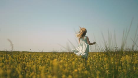 little girl running in a field of flowers