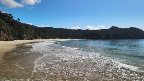 Flyover-New-Chums-Beach-surf,-Coromandel-Peninsula-New-Zealand